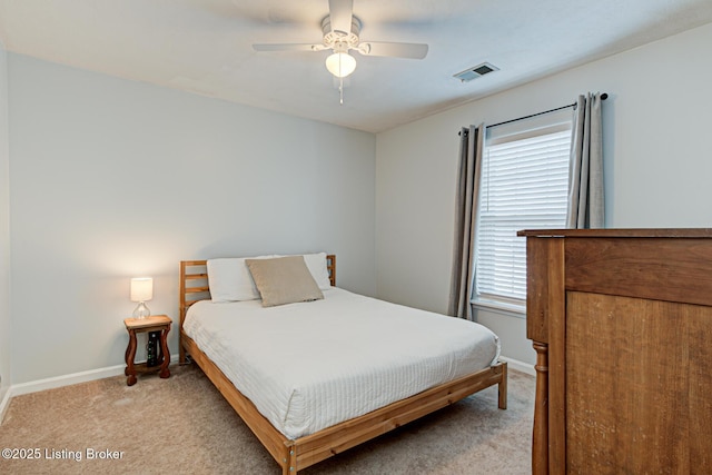 carpeted bedroom with ceiling fan and multiple windows