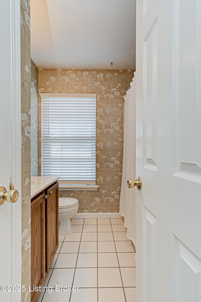 bathroom featuring tile patterned floors, vanity, and toilet