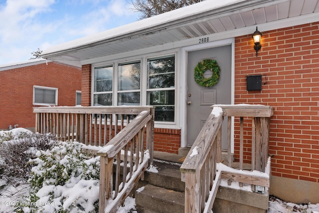 view of snow covered property entrance