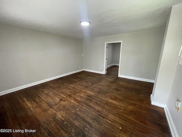 unfurnished room with dark hardwood / wood-style floors