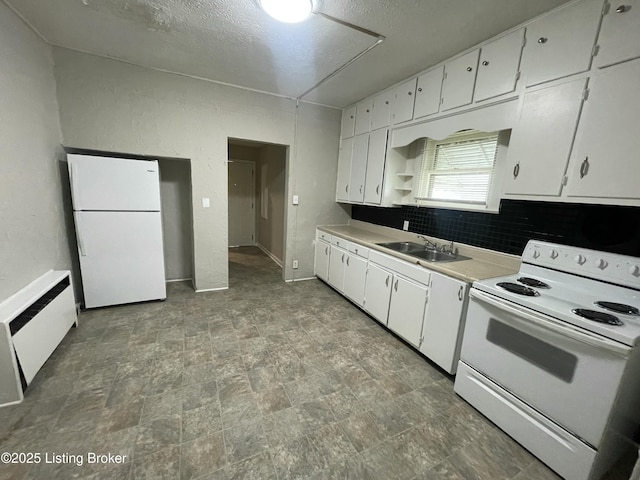 kitchen with white cabinets, white appliances, sink, and radiator