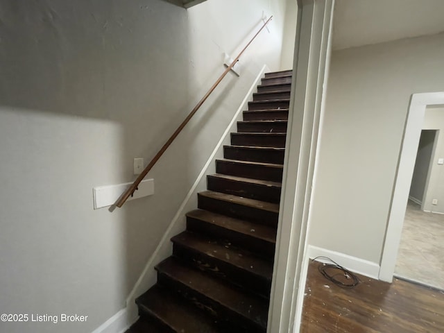 stairs featuring hardwood / wood-style floors