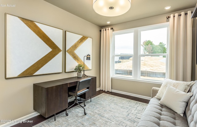 office with plenty of natural light and light hardwood / wood-style floors