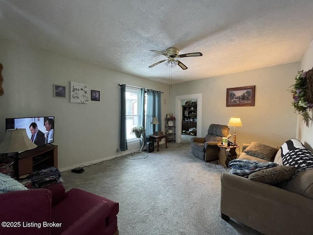 carpeted living room featuring ceiling fan and a textured ceiling