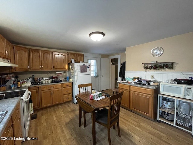 kitchen featuring light hardwood / wood-style floors and white appliances