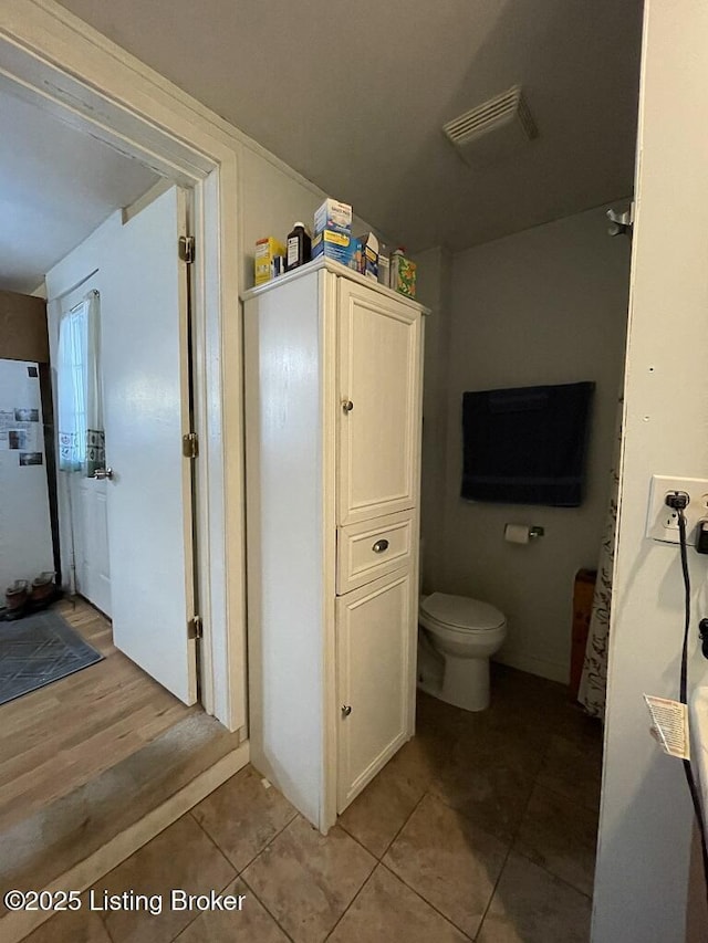 bathroom featuring tile patterned floors and toilet