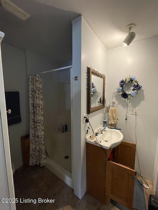 bathroom with a shower with curtain, vanity, and tile patterned floors