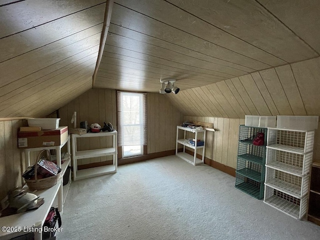 additional living space with wood walls, wood ceiling, light carpet, and vaulted ceiling