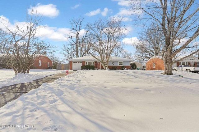 yard covered in snow featuring a garage