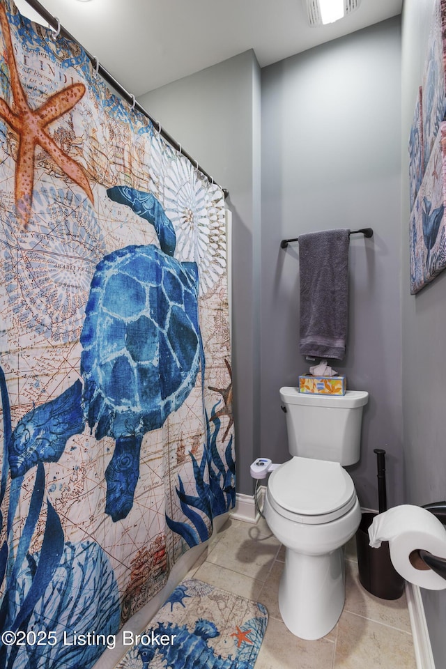 bathroom with tile patterned floors and toilet