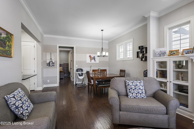 living room with crown molding, a notable chandelier, and dark hardwood / wood-style floors