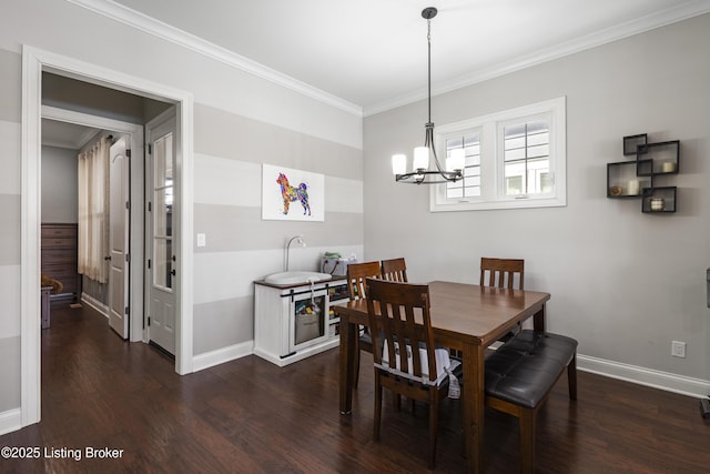 dining room featuring ornamental molding, dark hardwood / wood-style flooring, and an inviting chandelier