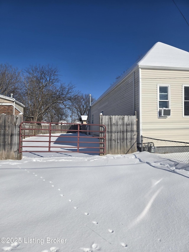 view of snowy exterior with cooling unit