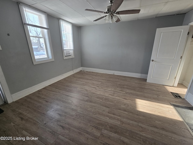 spare room with hardwood / wood-style flooring, a drop ceiling, ceiling fan, and cooling unit