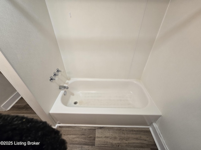 bathroom with a bath and wood-type flooring