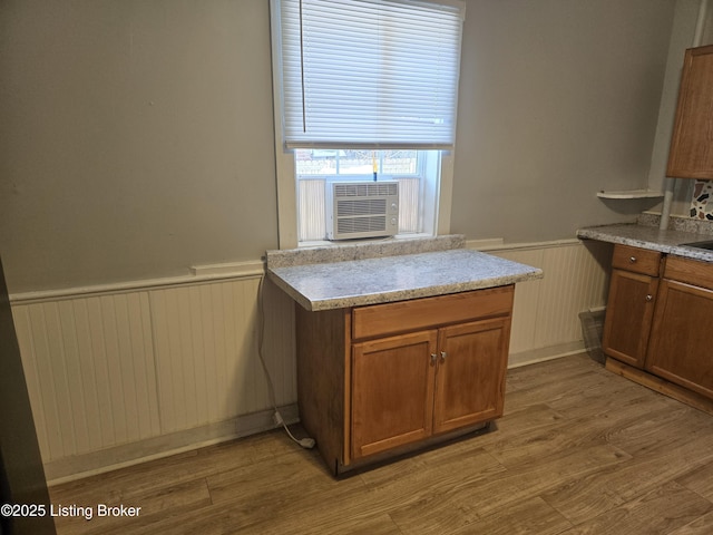 kitchen featuring cooling unit and light hardwood / wood-style floors