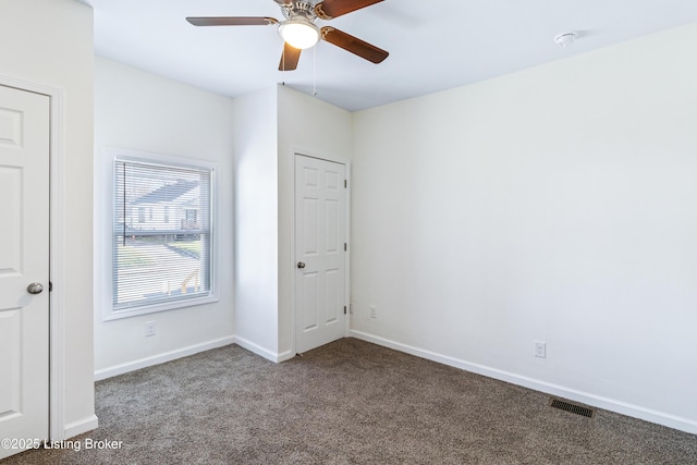 empty room with carpet flooring and ceiling fan