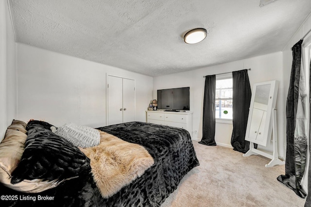 carpeted bedroom featuring a textured ceiling