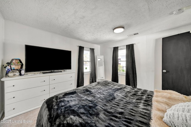 carpeted bedroom with a textured ceiling