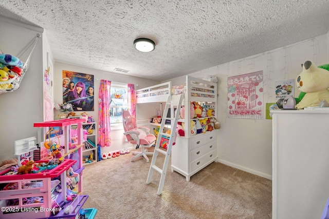 bedroom with a textured ceiling and light colored carpet