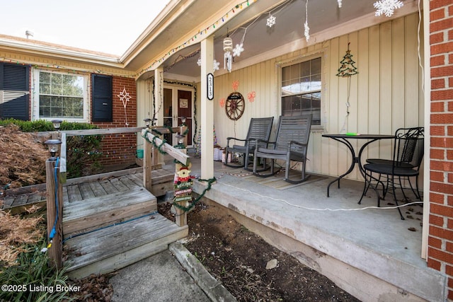 view of exterior entry with a porch