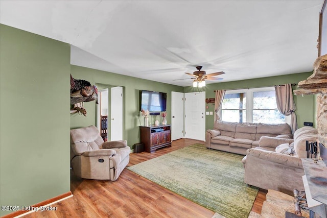 living room with ceiling fan and light hardwood / wood-style floors