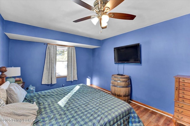 bedroom featuring wood-type flooring and ceiling fan