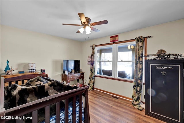 bedroom featuring wood-type flooring and ceiling fan