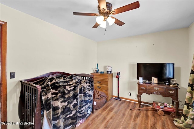 bedroom with ceiling fan and light hardwood / wood-style flooring