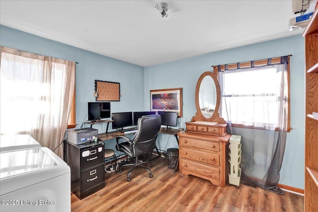 home office featuring separate washer and dryer, a wealth of natural light, and wood-type flooring