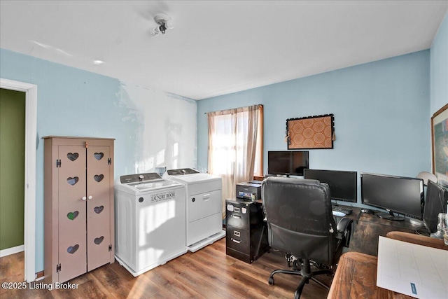 office area featuring washing machine and clothes dryer and hardwood / wood-style flooring