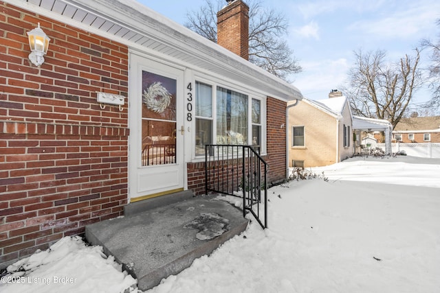 view of snow covered property entrance