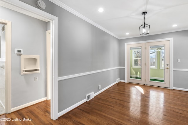 unfurnished dining area with ornamental molding and dark wood-type flooring