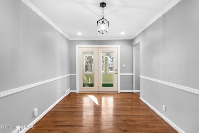 entryway featuring ornamental molding and dark hardwood / wood-style flooring