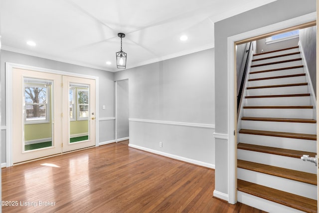 interior space with hardwood / wood-style floors and crown molding