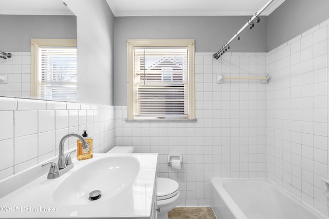 full bathroom featuring toilet, crown molding, tile walls, sink, and shower / bathing tub combination