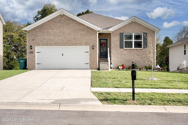 view of front of property featuring a front yard and a garage