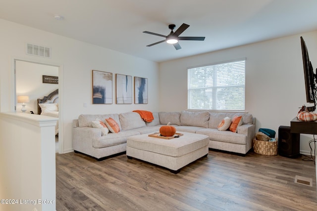 living room featuring hardwood / wood-style flooring and ceiling fan