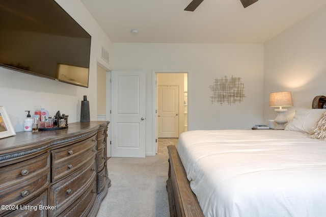 bedroom with ceiling fan and light colored carpet