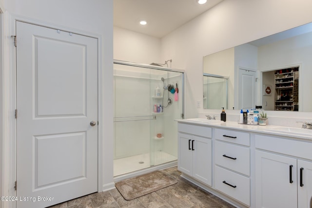 bathroom featuring vanity and a shower with shower door