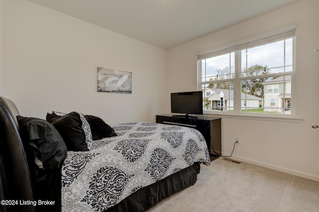 bedroom featuring light colored carpet