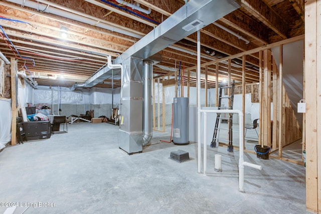 basement featuring heating unit and water heater