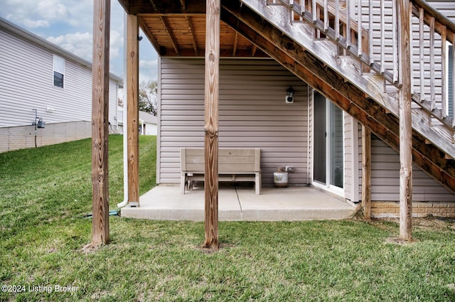 back of property featuring a patio area and a lawn