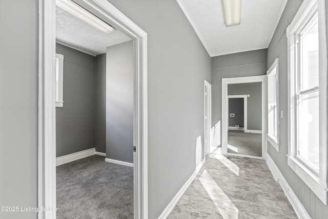 hallway featuring light colored carpet