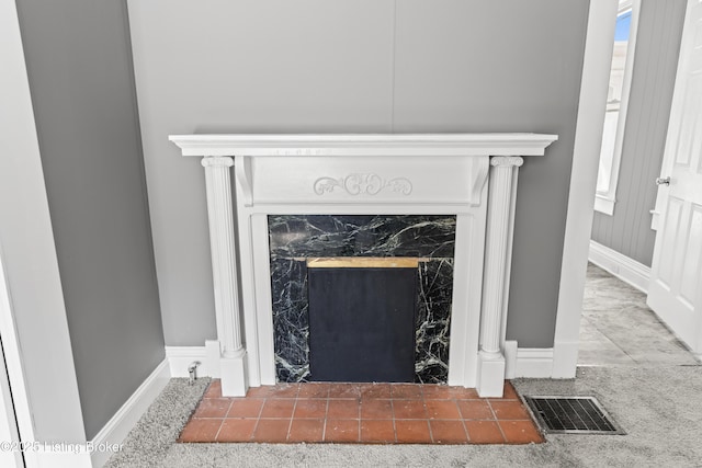 details featuring a high end fireplace and carpet flooring