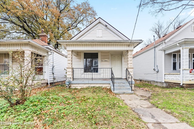 bungalow-style home featuring a porch and a front lawn