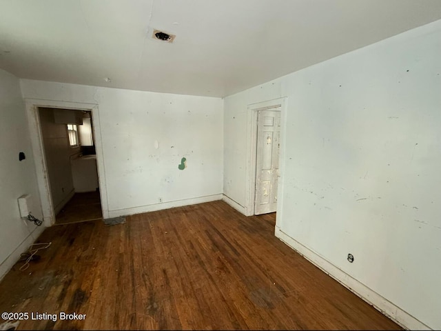 empty room with dark wood-type flooring