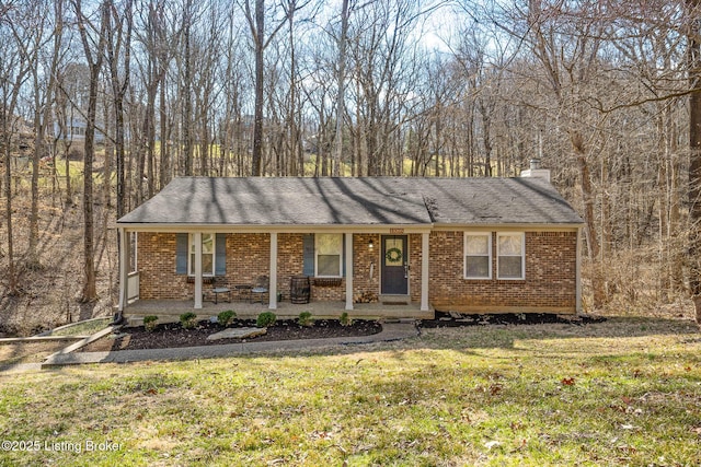 ranch-style house with brick siding, a porch, a chimney, and a front lawn