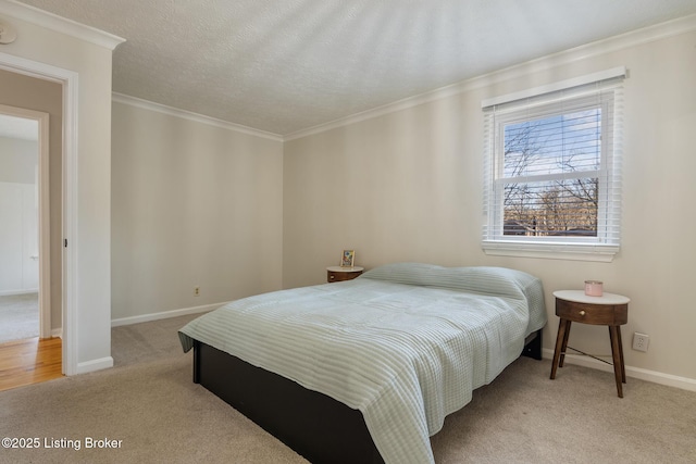 carpeted bedroom featuring baseboards, a textured ceiling, and crown molding