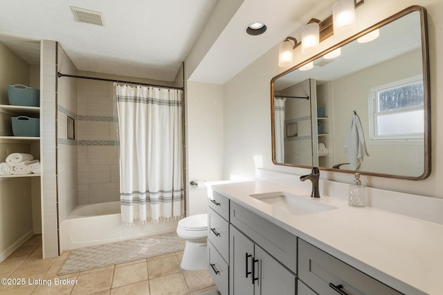 bathroom with vanity, visible vents, shower / bath combo, tile patterned floors, and toilet